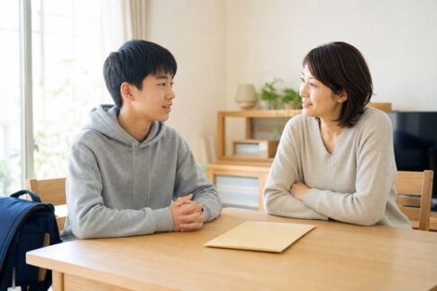 明るいダイニングで、中学3年生の息子と母親が成績表の封筒を前に穏やかに話し合っている様子