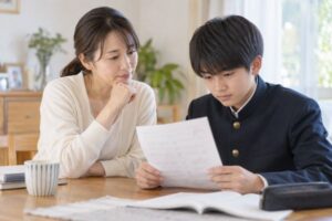 答案を前に、母親と中学生の息子が個別指導塾の成果について話している場面