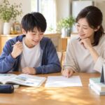 ダイニングテーブルで中1の男子生徒と母親が英語のテスト範囲表を一緒に確認している様子